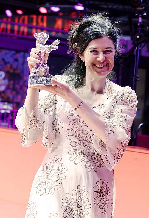 Anna Fitch poses with the Silver Bear for Outstanding Artistic Contribution for Yo (Love is a Rebellious Bird) on the red carpet after the Award Ceremony of Berlinale 2026 in Berlin, Germany