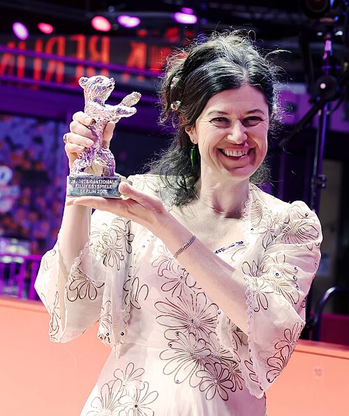 Anna Fitch poses with the Silver Bear for Outstanding Artistic Contribution for Yo (Love is a Rebellious Bird) on the red carpet after the Award Ceremony of Berlinale 2026 in Berlin, Germany