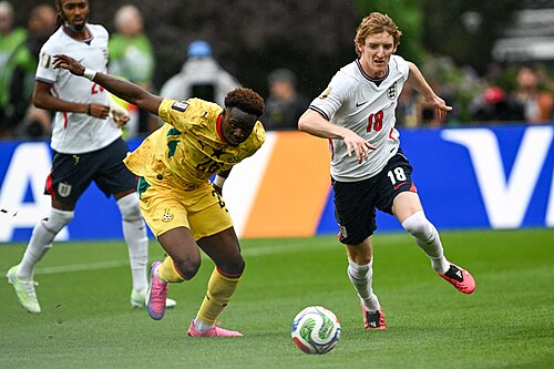 FOXBOROUGH, UNITED STATES - June 23: Anthony Gordon #18 of England is in action against Marvin Senaya #26 of Ghana during the FIFA World Cup 2026 Group L match between England and Ghana on June 23, 2026 Boston Stadium , Foxborough, Massachusetts