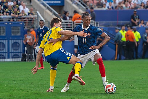 Besfort Zeneli Michael Olise during France v Sweden at the 2026 FIFA World Cup