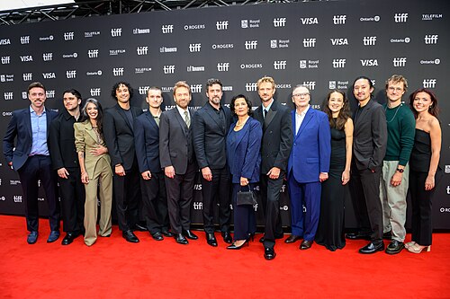 From left to right: Steven Demmler, Kalama Epstein, Gheed, Sean Bernardini, Lucian Patton, Kenneth Branagh, Reed Van Dyk, Hiam Abbass, Boyd Holbrook, Wayne Rogers, Chelsi Johnston, Jon Peter, Zak Engel, Ava Skolnik. At the screening of Atonement at the 2026 Toronto International Film Festival.