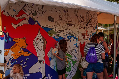 Attendees of Dominion Energy Riverrock on May, 15, 2026 painting a community mural