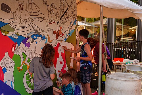 Attendees of Dominion Energy Riverrock on May, 15, 2026 painting a community mural
