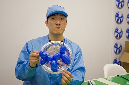 Dahoon Nam, artist, performing for "Jeff Koons Special Sale" at Basel Social Club 2025.