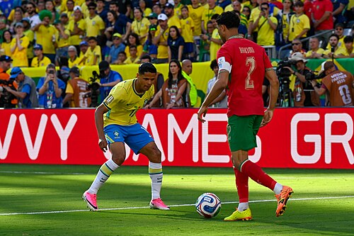 EAST RUTHERFORD, UNITED STATES - June 14: Douglas Santos of Brazil competes for the ball against Achraf Hakimi of Morocco during the FIFA World Cup 2026 Group C match between Brazil and Morocco on June 14, 2026