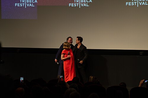 Director Drake Doremus alongside actress Emilia  Clarke and actor Édgar Ramírez on stage during the world premiere of "Next Life" at the Tribeca Film Festival 2026.