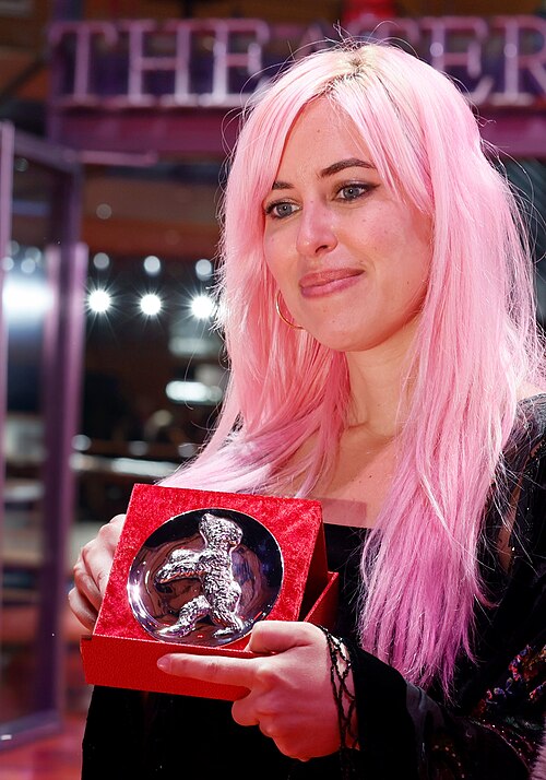 Fanny Texier poses with the Silver Bear Jury Prize (Short Film) for A Woman’s Place Is Everywhere on the red carpet after the Award Ceremony of Berlinale 2026 in Berlin, Germany