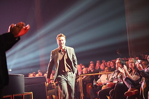 Glen Powell walking to stage at CinemaCon 2025 where he was honored with the Star of the Year at the Screen Achievement Awards at Caesar's Palace at Las Vegas, NV