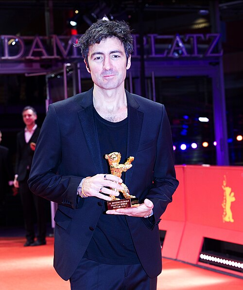 Ilker Çatak pose with the Golden Bear for Best Film for “Gelbe Briefe (Yellow Letters)” on the red carpet after the Award Ceremony of Berlinale 2026 in Berlin, Germany
