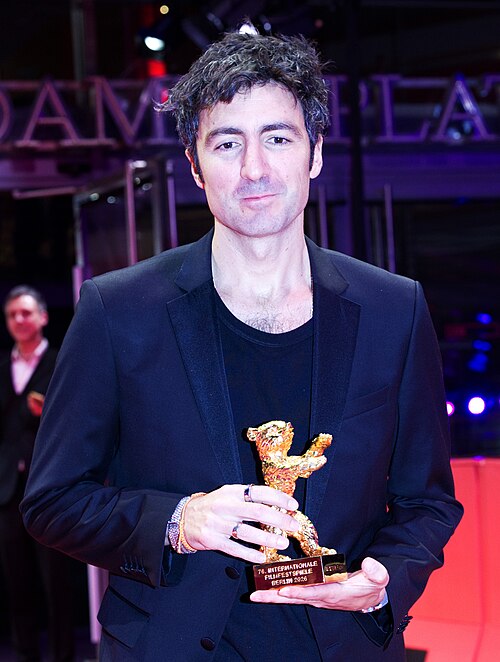 Ilker Çatak pose with the Golden Bear for Best Film for “Gelbe Briefe (Yellow Letters)” on the red carpet after the Award Ceremony of Berlinale 2026 in Berlin, Germany