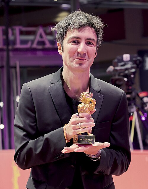 Ilker Çatak pose with the Golden Bear for Best Film for “Gelbe Briefe (Yellow Letters)” on the red carpet after the Award Ceremony of Berlinale 2026 in Berlin, Germany