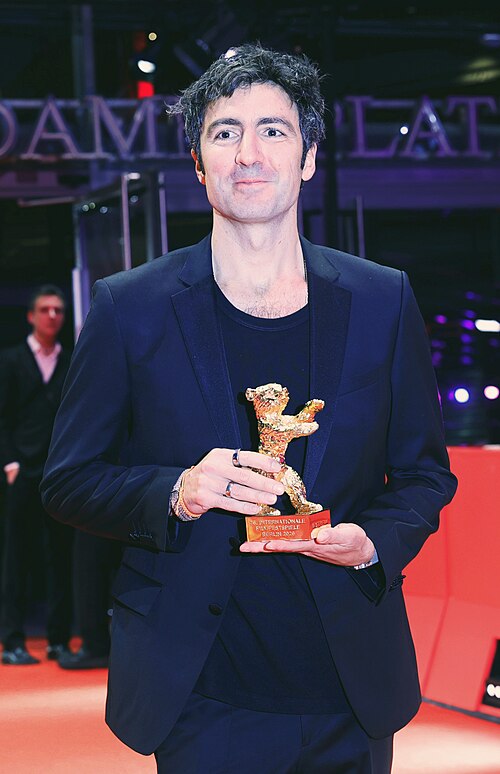 Ilker Çatak pose with the Golden Bear for Best Film for “Gelbe Briefe (Yellow Letters)” on the red carpet after the Award Ceremony of Berlinale 2026 in Berlin, Germany