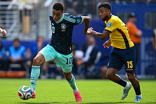EAST RUTHERFORD, UNITED STATES - June 25: Jamal Musiala #10 of Germany is in action against, Pedro Vite #15 of Ecuador during the FIFA World Cup 2026 Group E match between Ecuador  and  Germany on June 25, 2026 MetLife Stadium, East Rutherford, New Jersey