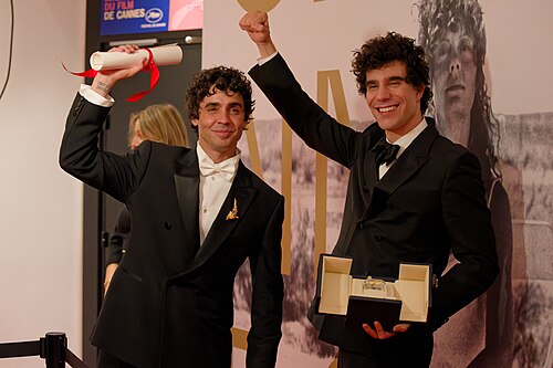 Javier Ambrossi (left) and Javier Calvo (right) at the 2026 Cannes Film Festival winners press conference, holding their award