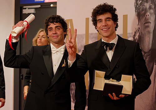Javier Ambrossi (left) and Javier Calvo (right) at the 2026 Cannes Film Festival winners press conference, holding their award