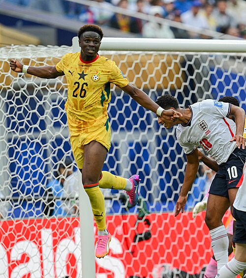 FOXBOROUGH, UNITED STATES - June 23: Marvin Senaya #26 of Ghana battles in the air with Jude Bellingham #10 of England during the FIFA World Cup 2026 Group L match between England and Ghana on June 23, 2026 Boston Stadium , Foxborough, Massachusetts