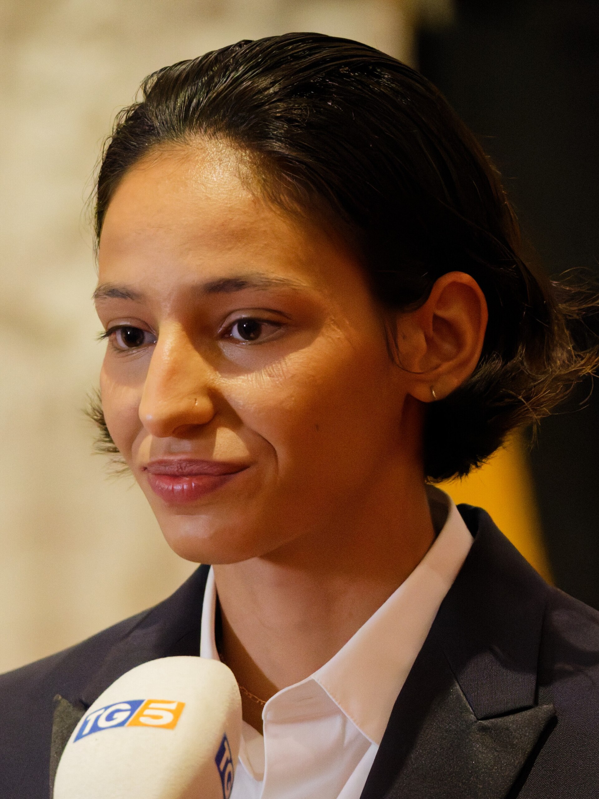Nadia Melliti being interviewed by press after winning an award at the 2025 Cannes Film Festival.
