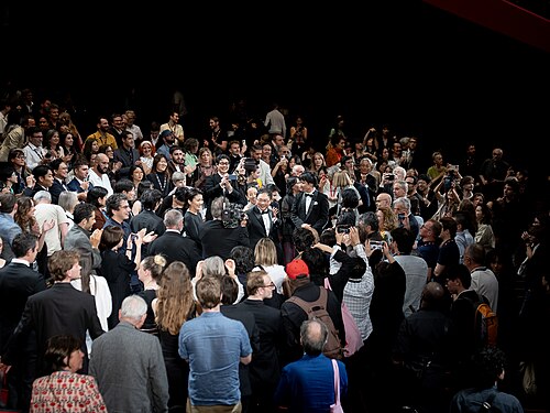 MAY 13, 2026 - Director Koji Fukada receiving a standing ovation at the premiere of his feature film Nagi Notes at the 2026 Cannes Film Festival.