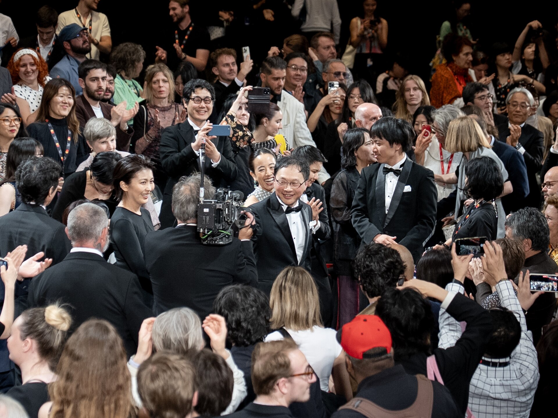 MAY 13, 2026 - Director Koji Fukada receiving a standing ovation at the premiere of his feature film Nagi Notes at the 2026 Cannes Film Festival.