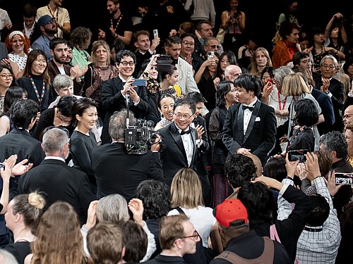 MAY 13, 2026 - Director Koji Fukada receiving a standing ovation at the premiere of his feature film Nagi Notes at the 2026 Cannes Film Festival.