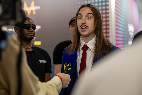 Tommy Cash, representing Estonia, being interviewed at Eurovision 2025 in Basel, Switzerland.