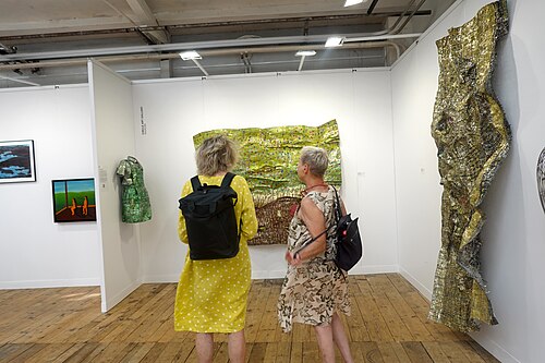 Viewers in front of art by Dickens Otenio of Kenya at Africa Basel at Art Basel 2025