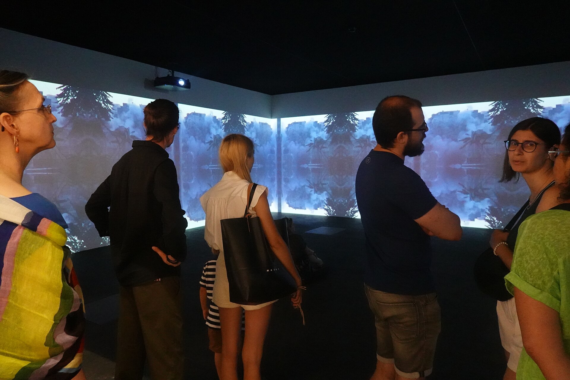 Viewers in front of Lebanese video artist Walid Raad's installation at Unlimited section of Art Basel 2025